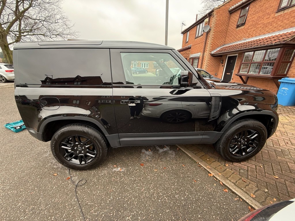 Defender 90 after — deep gloss black finish, side panels professionally cleaned and refreshed