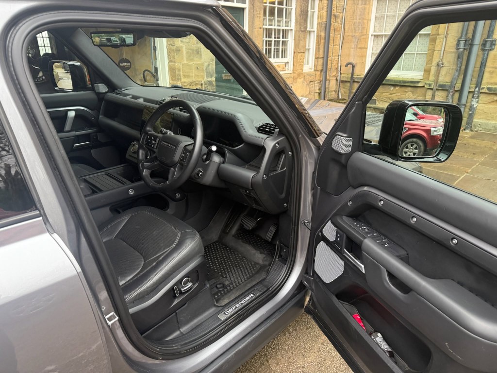 Defender interior after — clean floor mats, door sill deep cleaned and finished, fresh cabin